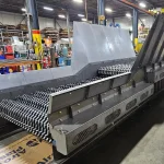 Steel glass crusher with rows of crushing rollers on the shop floor