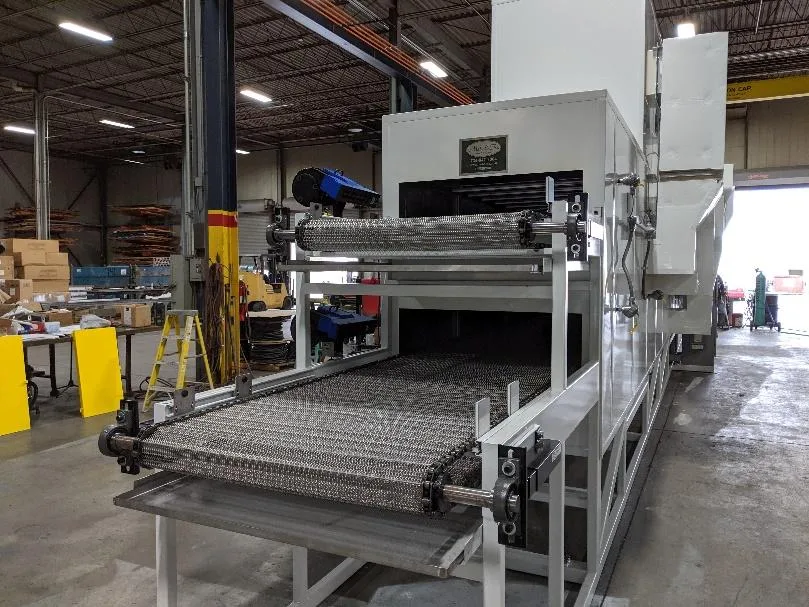 Mesh belt conveyor feeding into a white oven